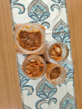 Overhead view of small batch Grounded Achar fermenting in glass jars